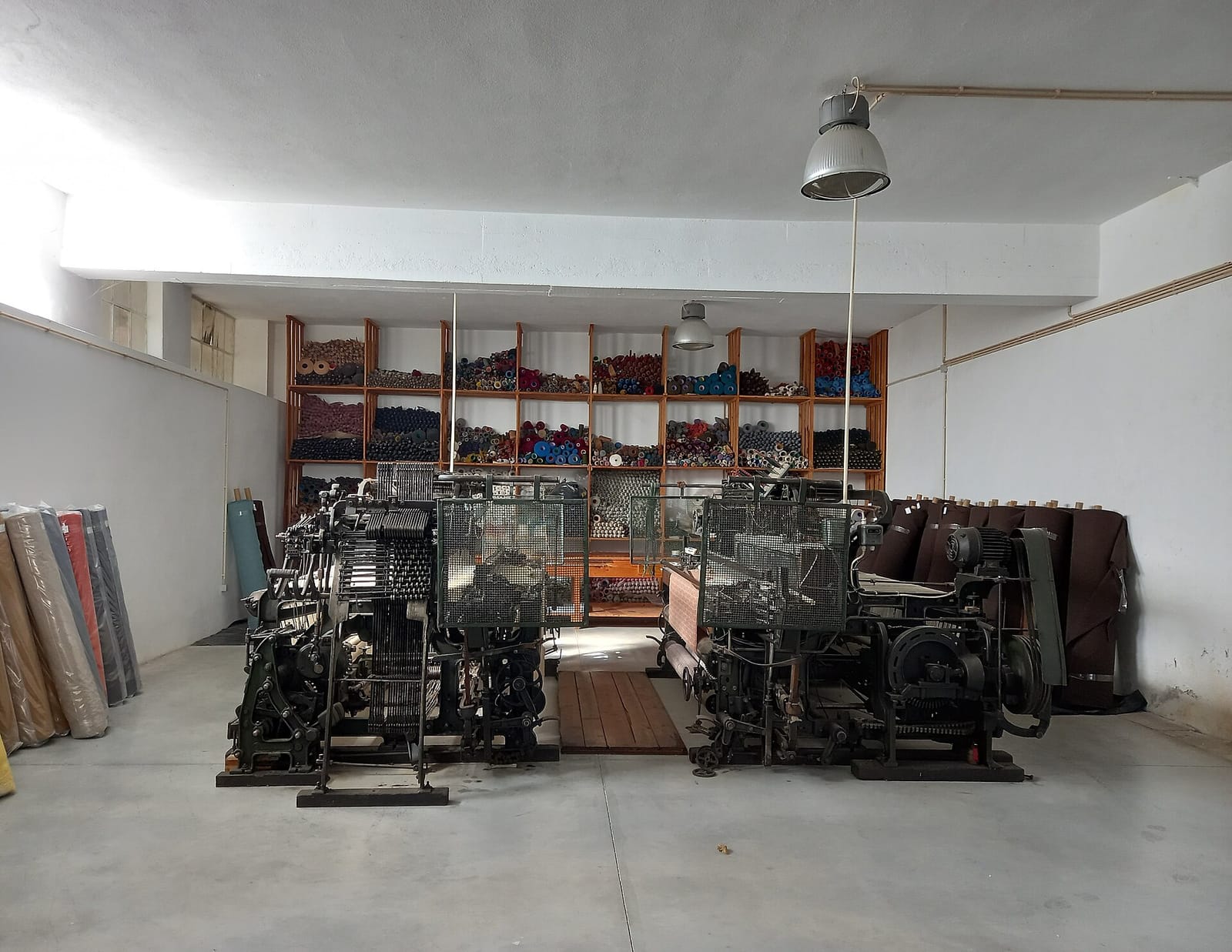 Looms and shelves of burel blankets at Burel Factory.